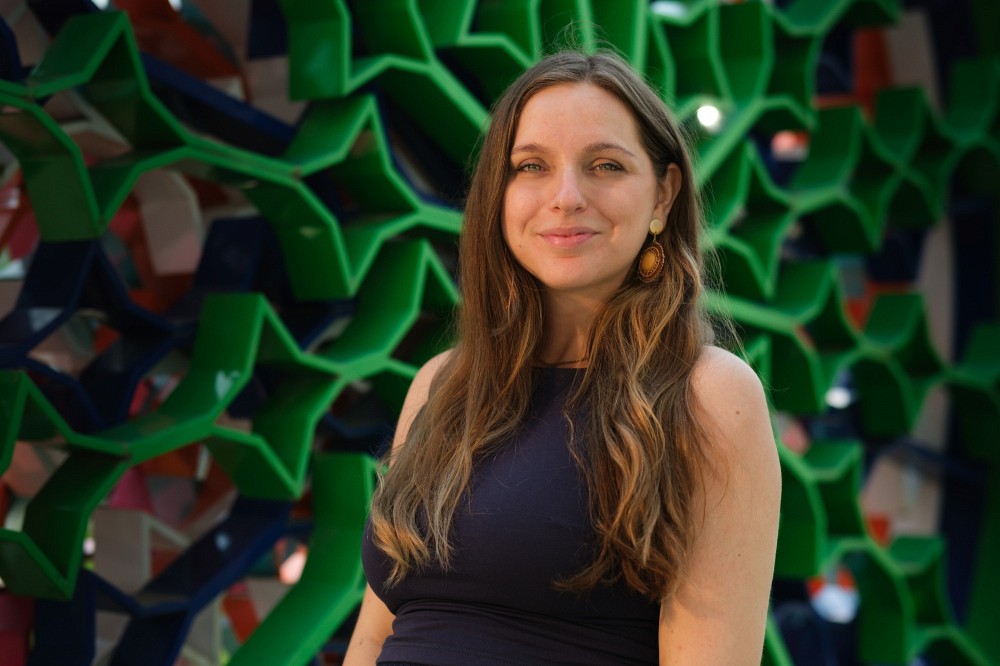 Chlo&eacute; Corbeil Smith,&nbsp;conseill&egrave;re principale aux relations et &agrave; l&rsquo;engagement avec les Premiers Peuples &agrave; l'UdeS, devant l'&oelig;uvre La vapeur de Sawyer de l'artiste autochtone Ludovic Boney, situ&eacute;e derri&egrave;re le Centre sportif, au Campus principal.